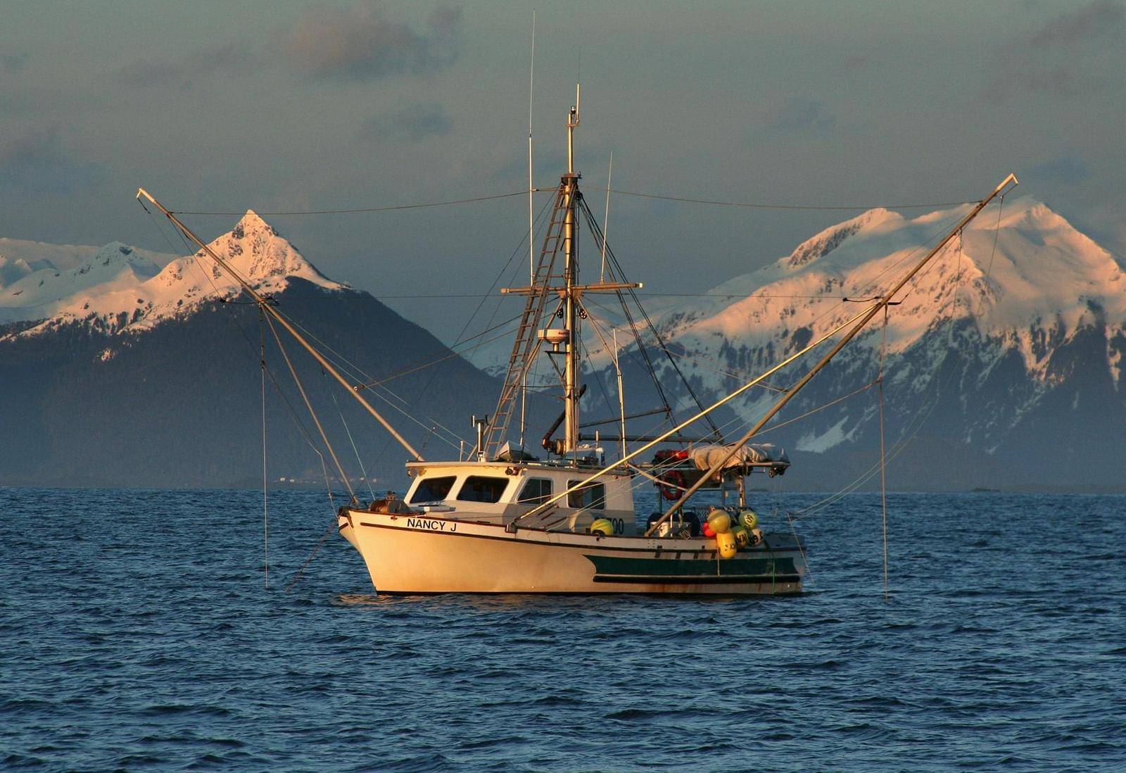 Fishing boat Nancy J with snowy Sitka mountains